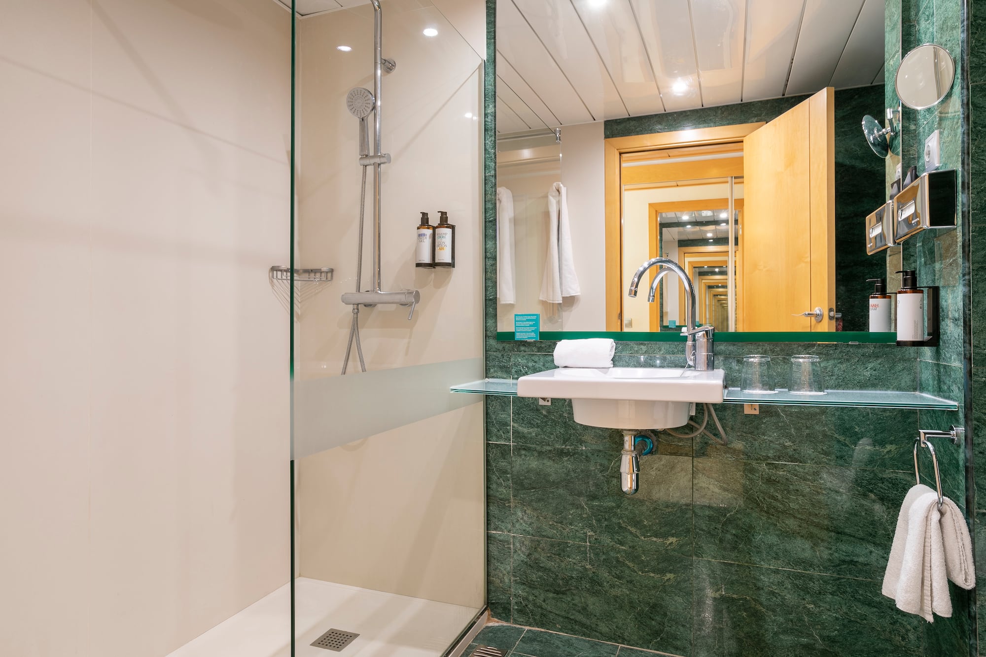 a bathroom with a glass shower and sink