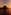 Sunset over ocean with dark rocky island silhouette, reflecting orange sky.