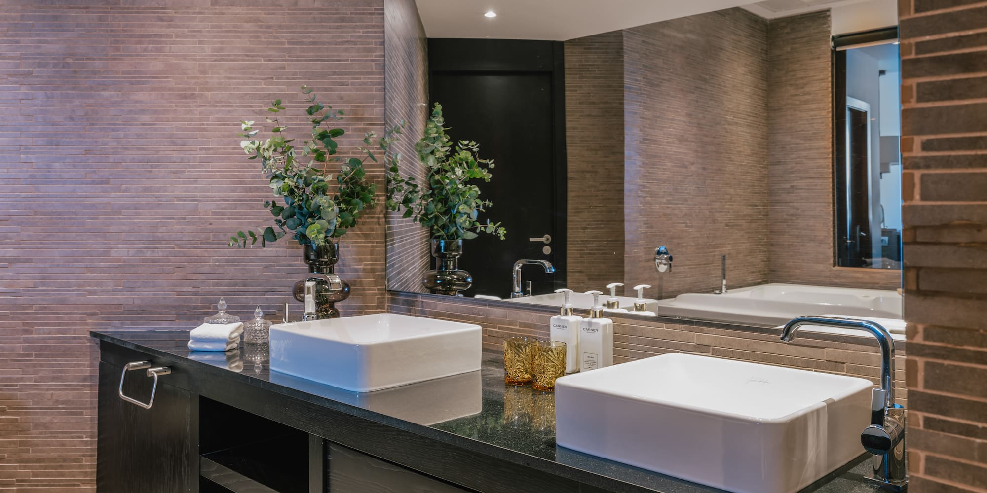 a bathroom with two sinks and a mirror