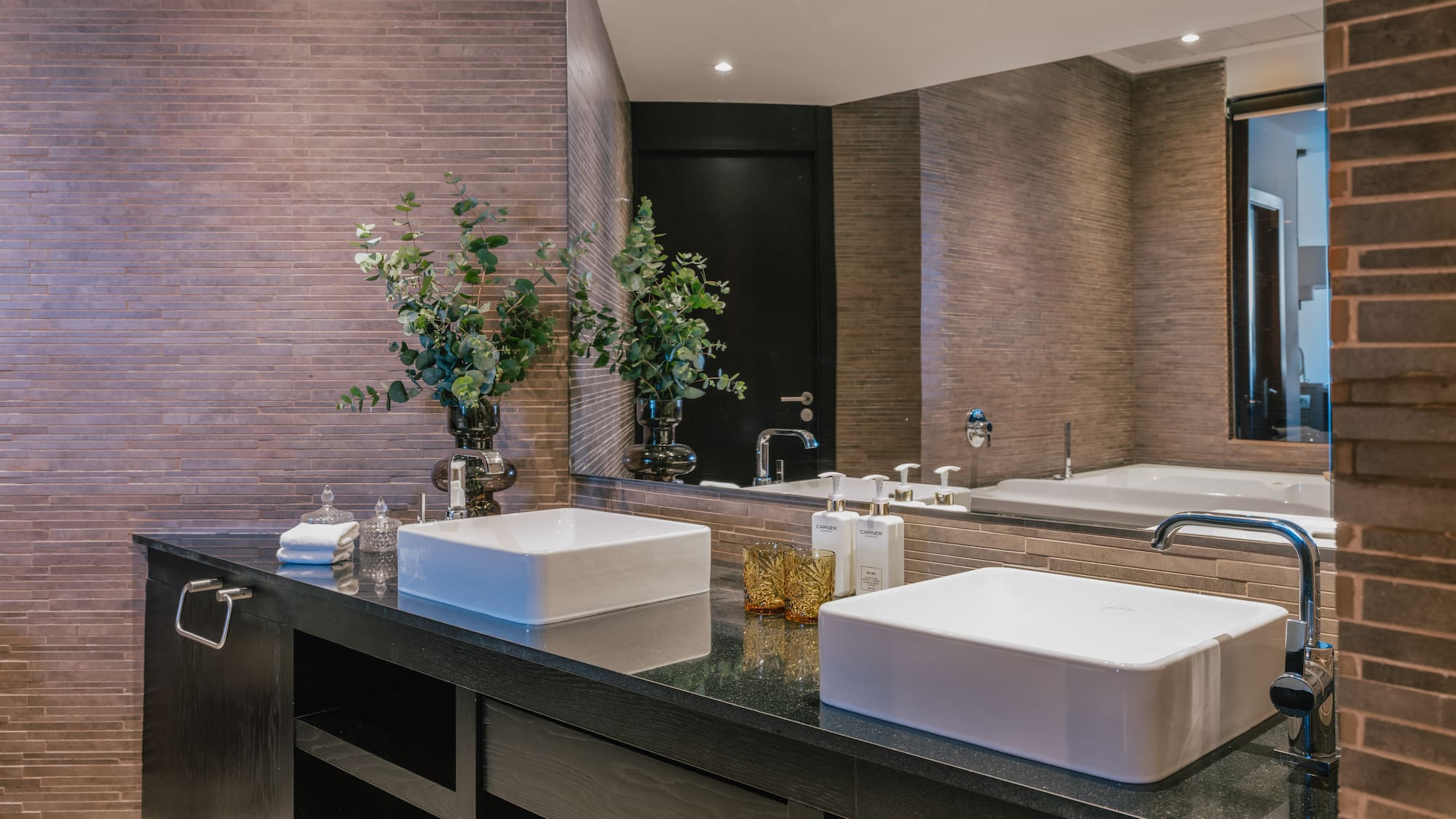 a bathroom with two sinks and a mirror