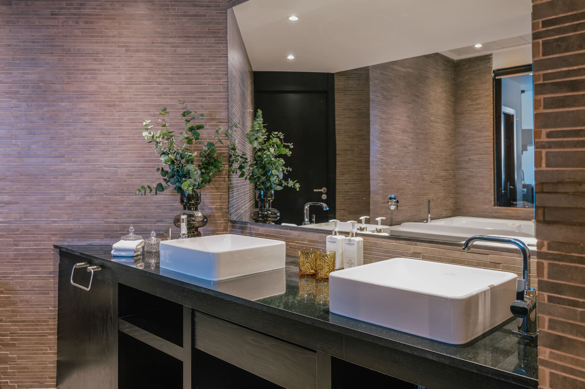 a bathroom with two sinks and a mirror