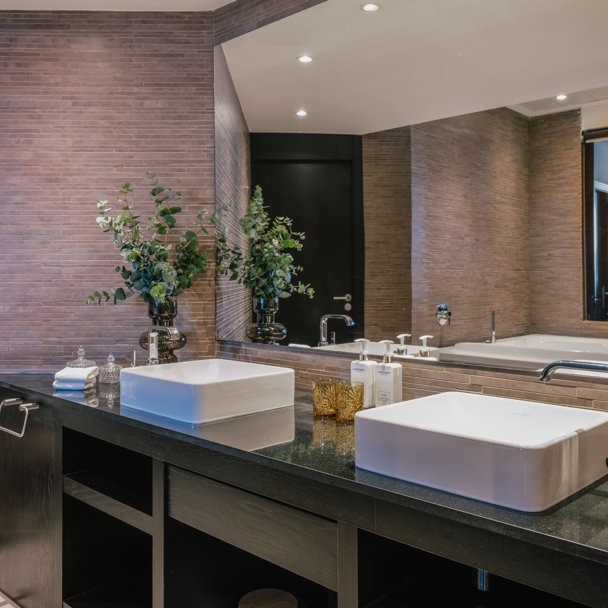 a bathroom with two sinks and a mirror