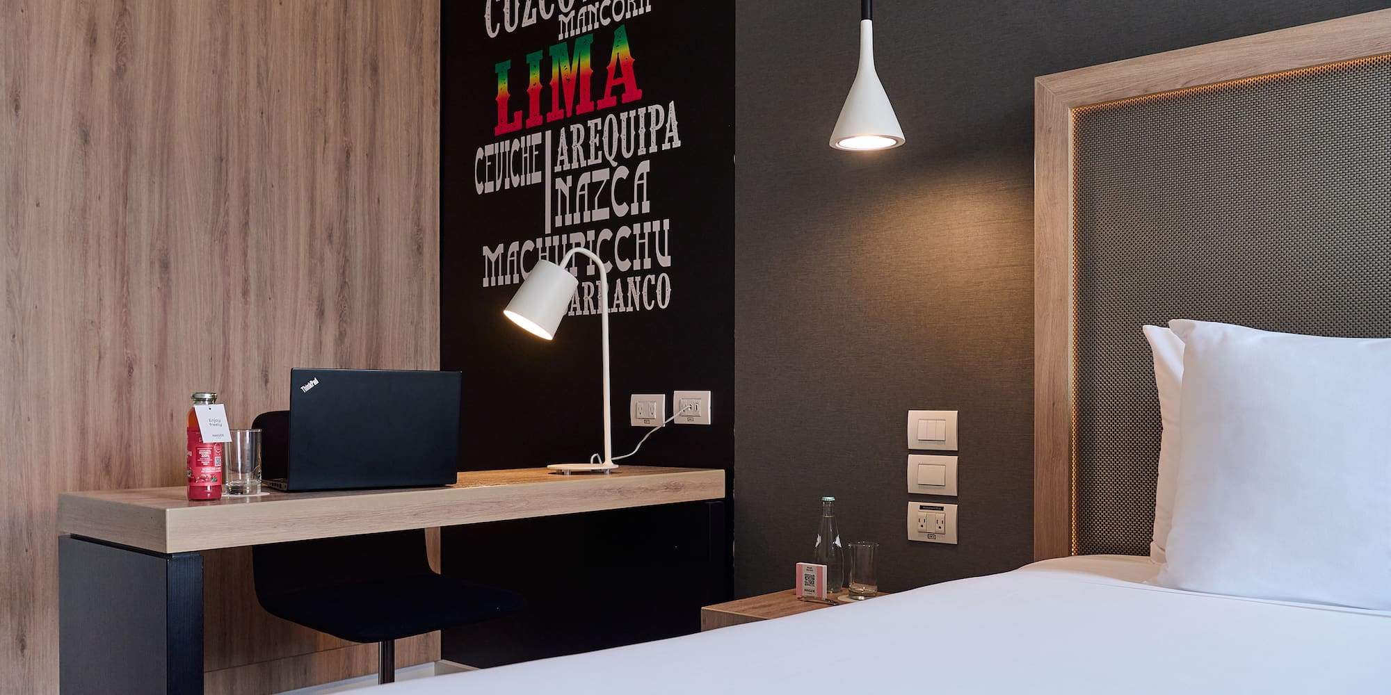 a room with a bed and a laptop