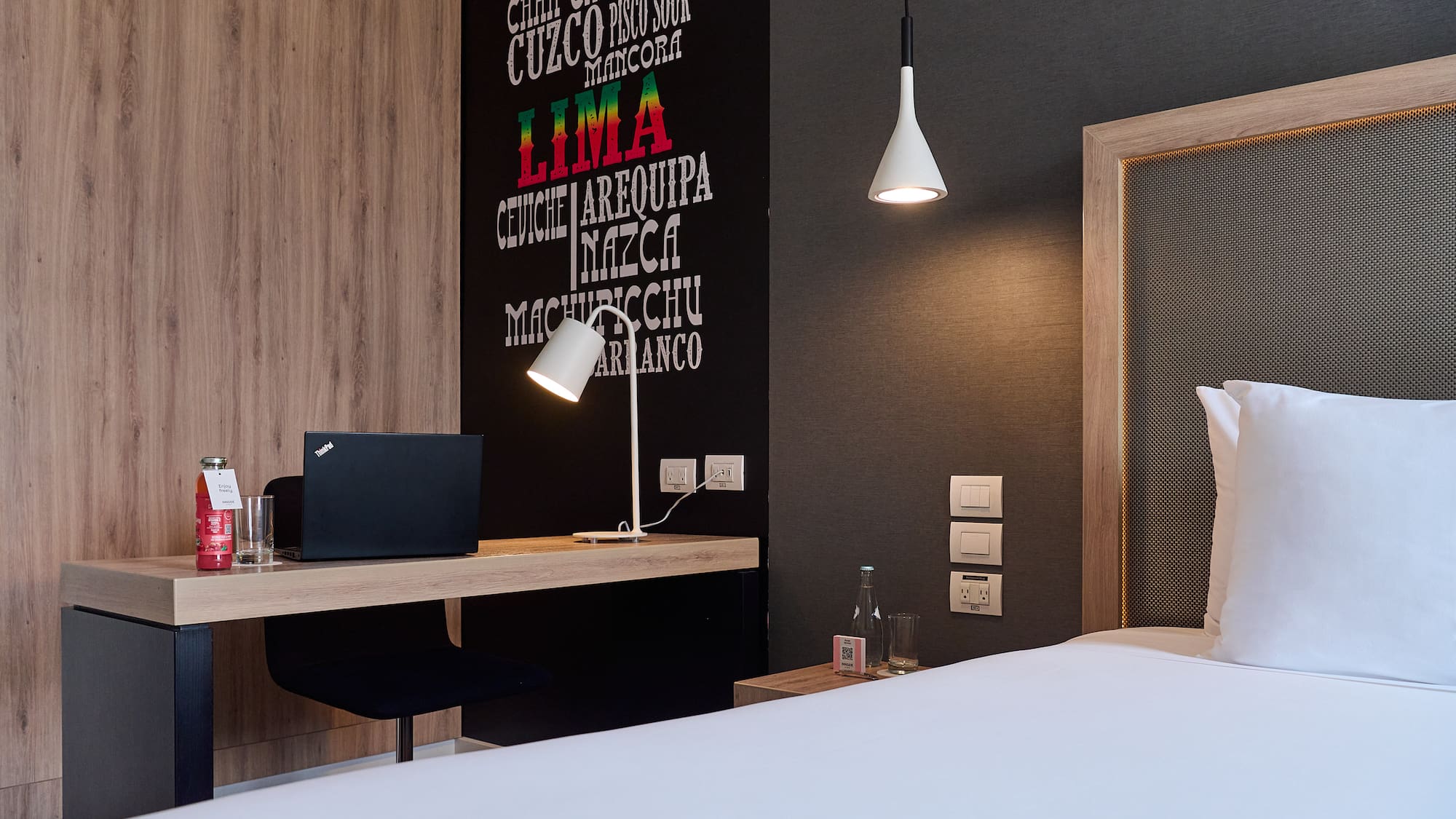 a room with a bed and a laptop