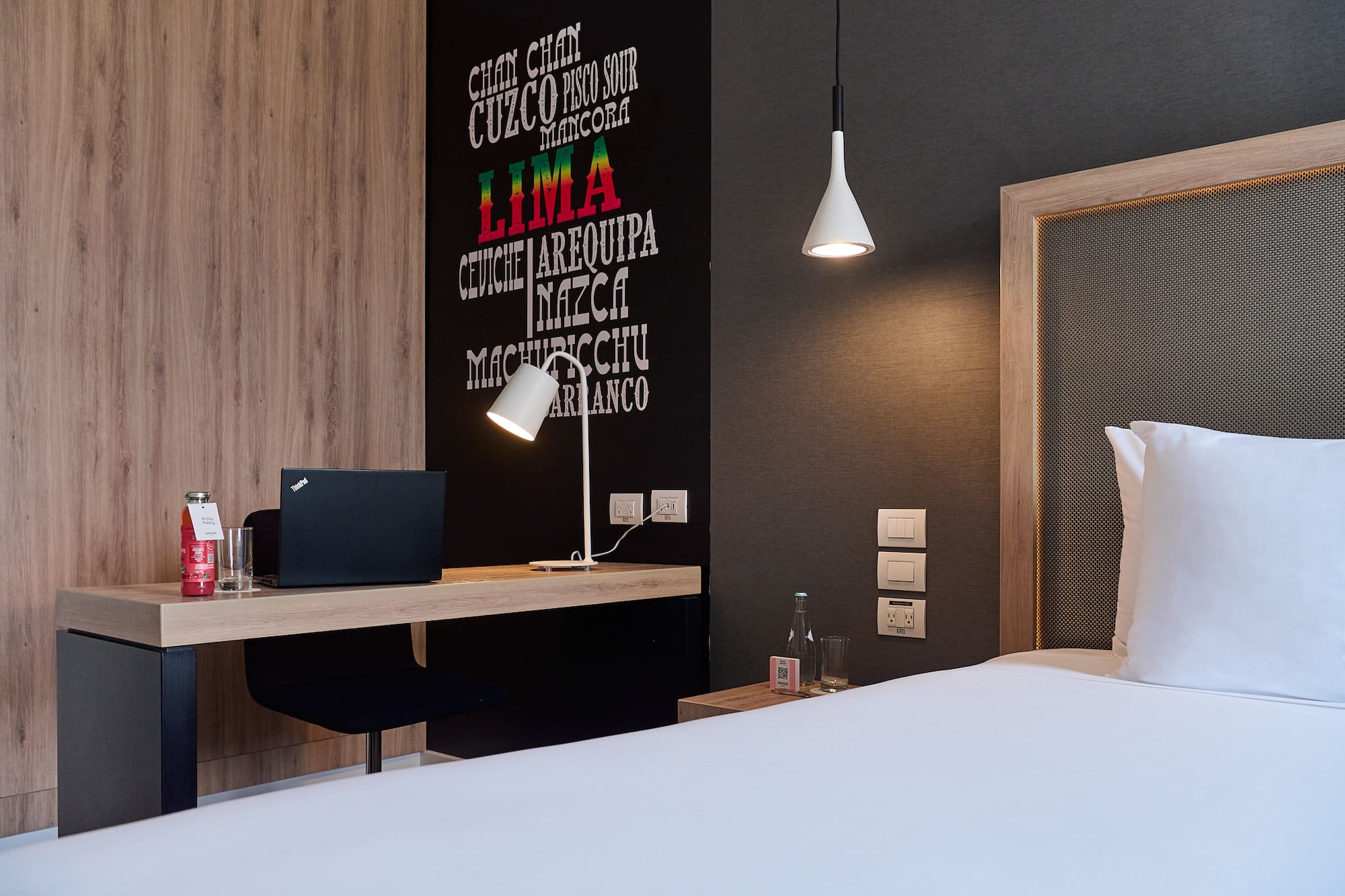 a room with a bed and a laptop