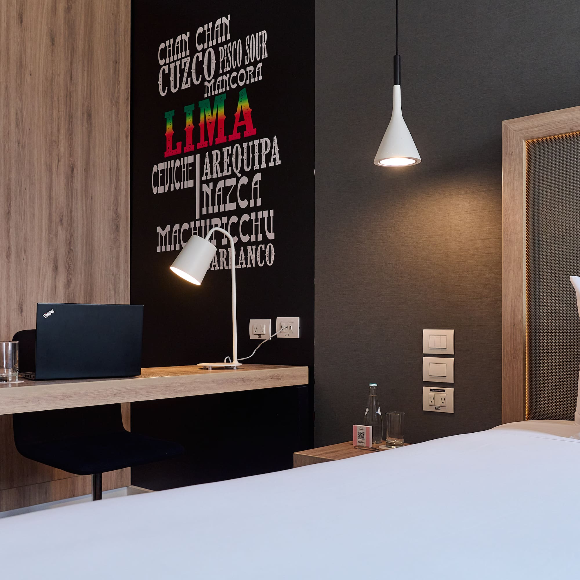 a room with a bed and a laptop