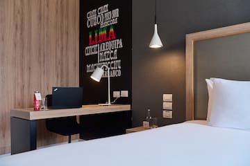 a room with a bed and a laptop