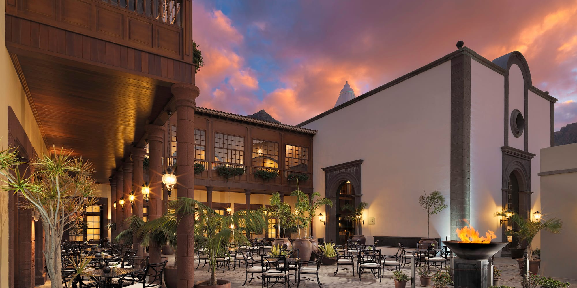 a courtyard with tables and chairs