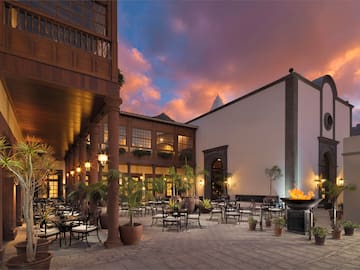 a courtyard with tables and chairs