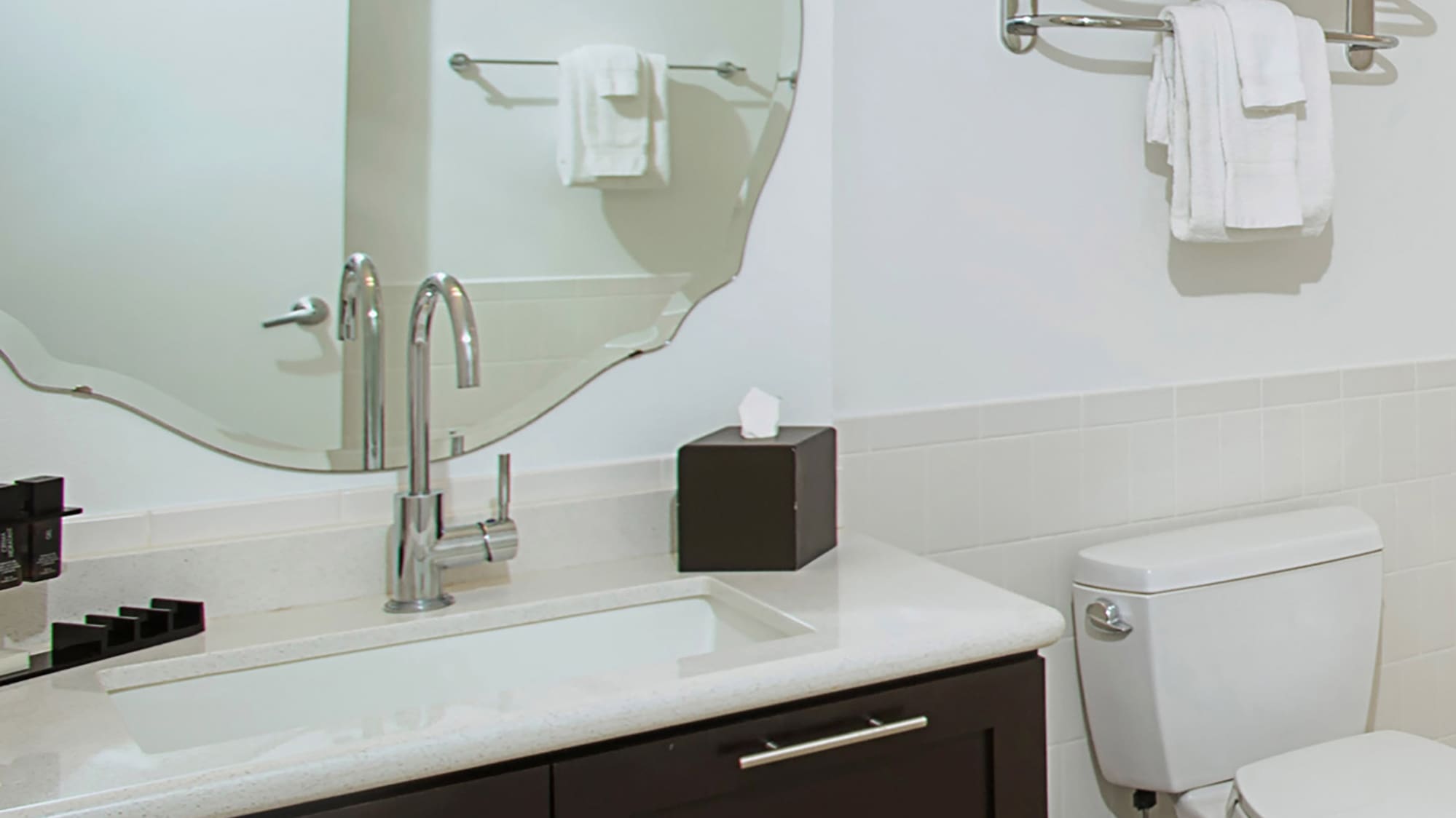 a bathroom with a mirror and a toilet