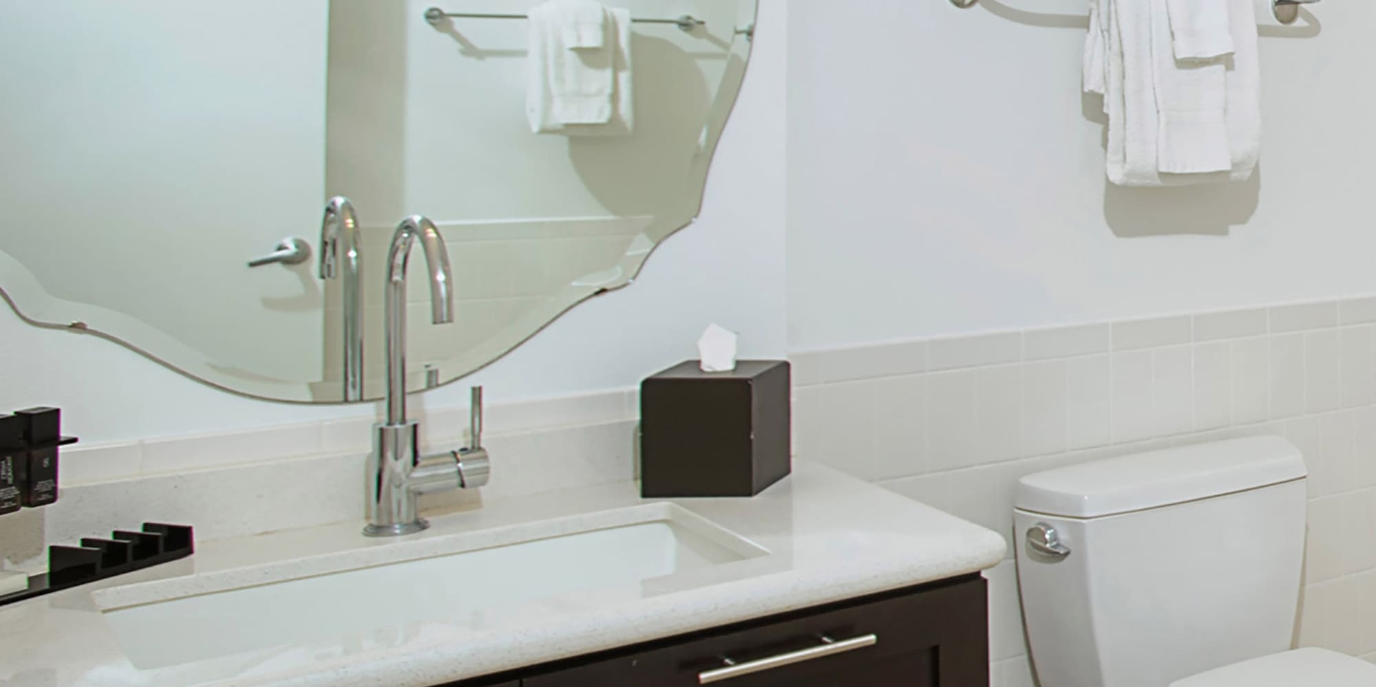 a bathroom with a mirror and a toilet