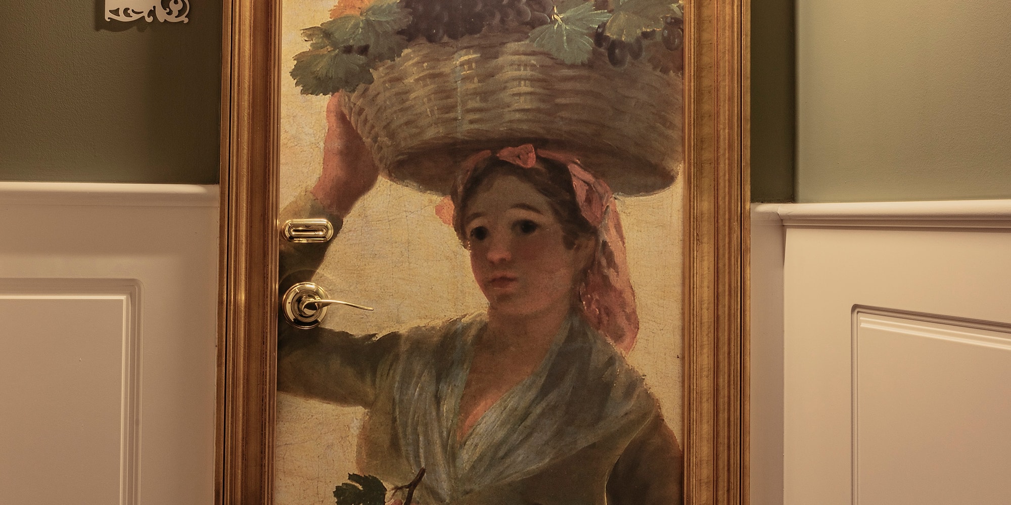 a painting of a woman holding a basket of vegetables on a door