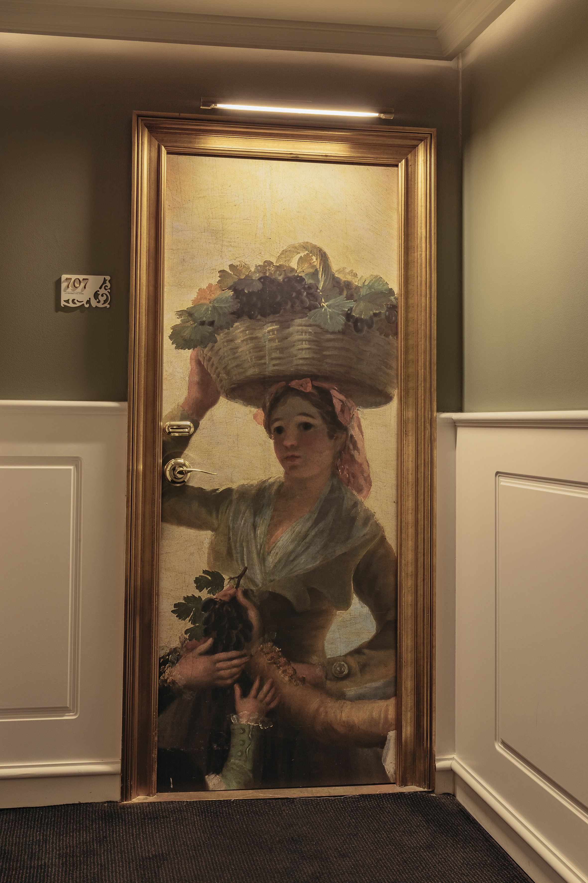 a painting of a woman holding a basket of fruits on her head