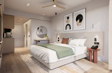 a bedroom with a bed and artwork on the wall