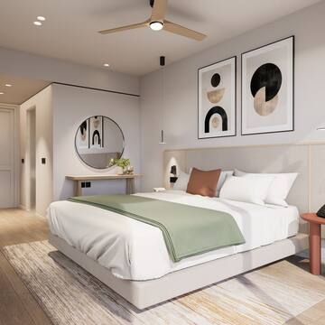 a bedroom with a bed and artwork on the wall