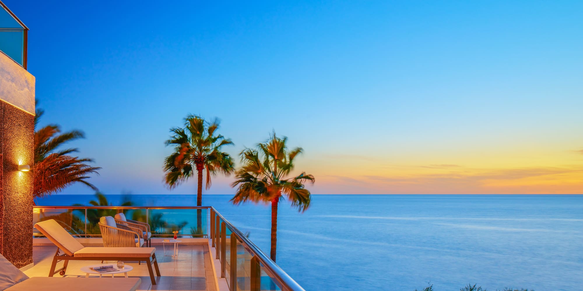 a deck with a pool and palm trees