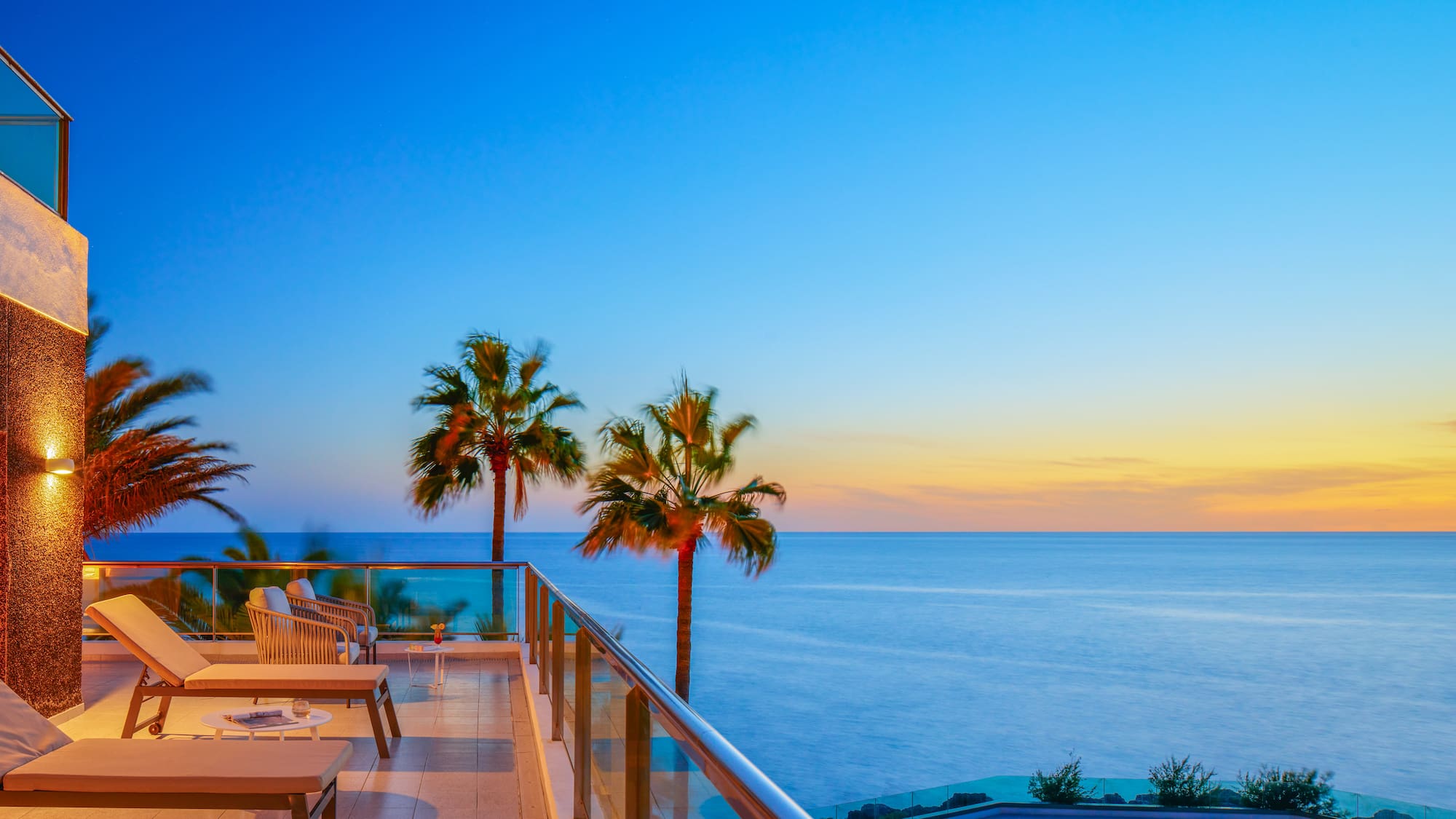 a deck with a pool and palm trees