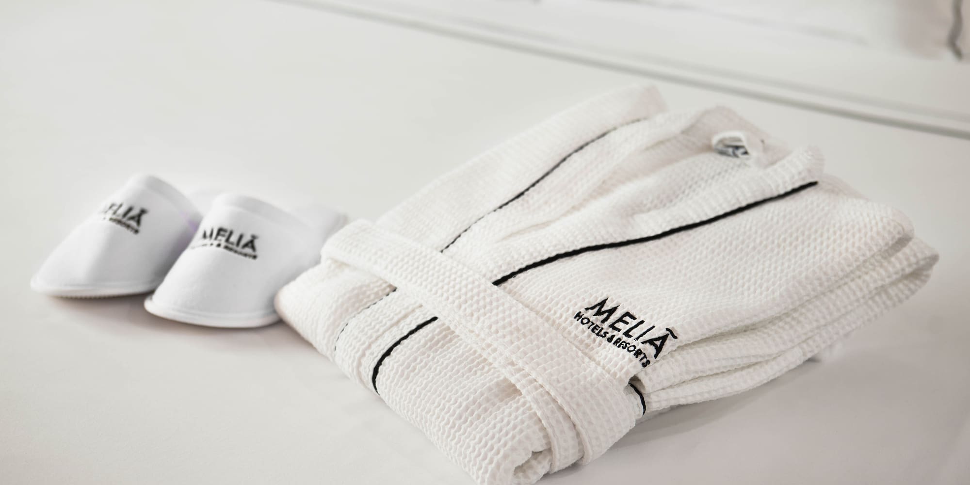 a hallway with doors and a light on the wall