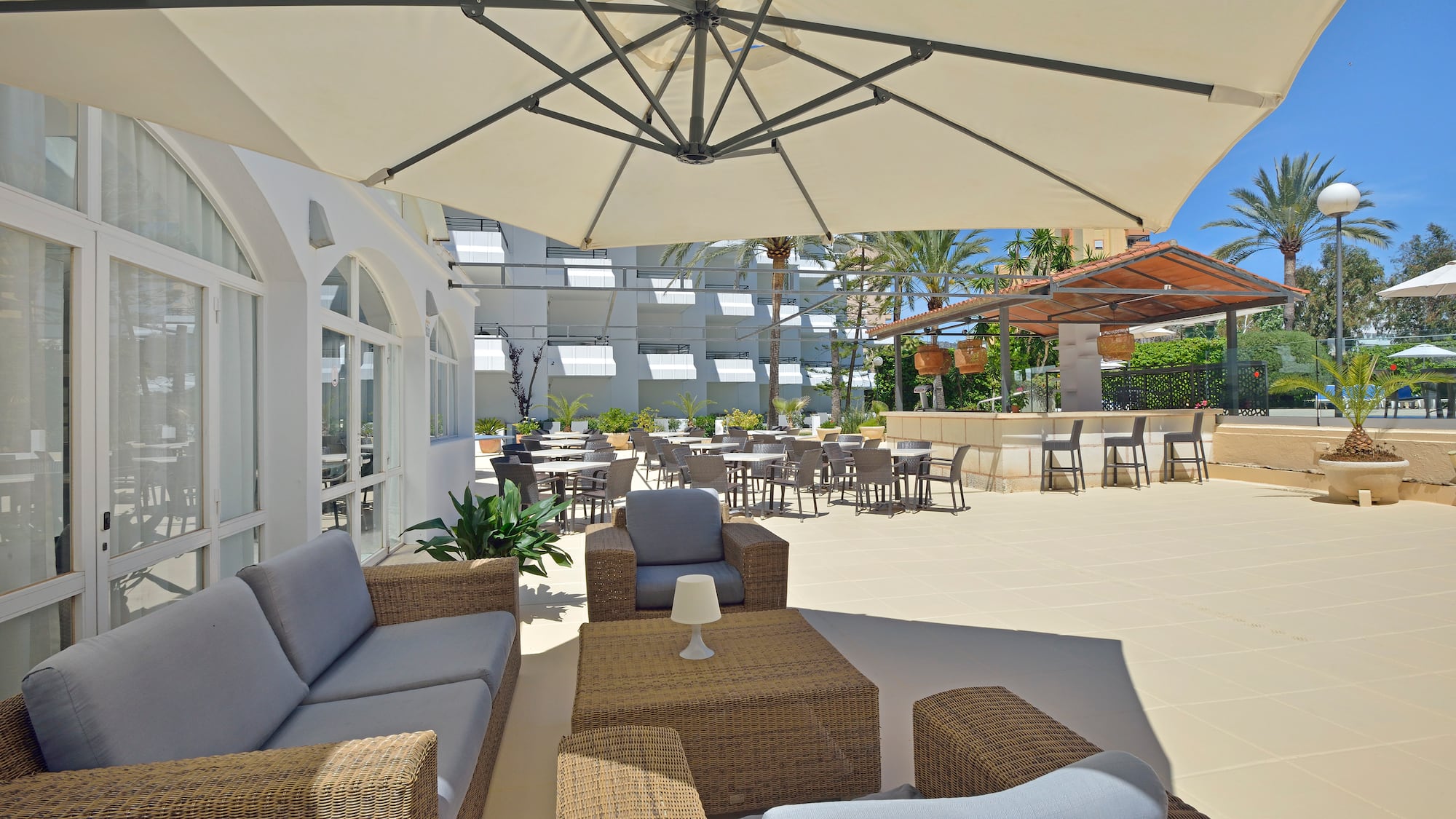 a patio area with chairs and tables