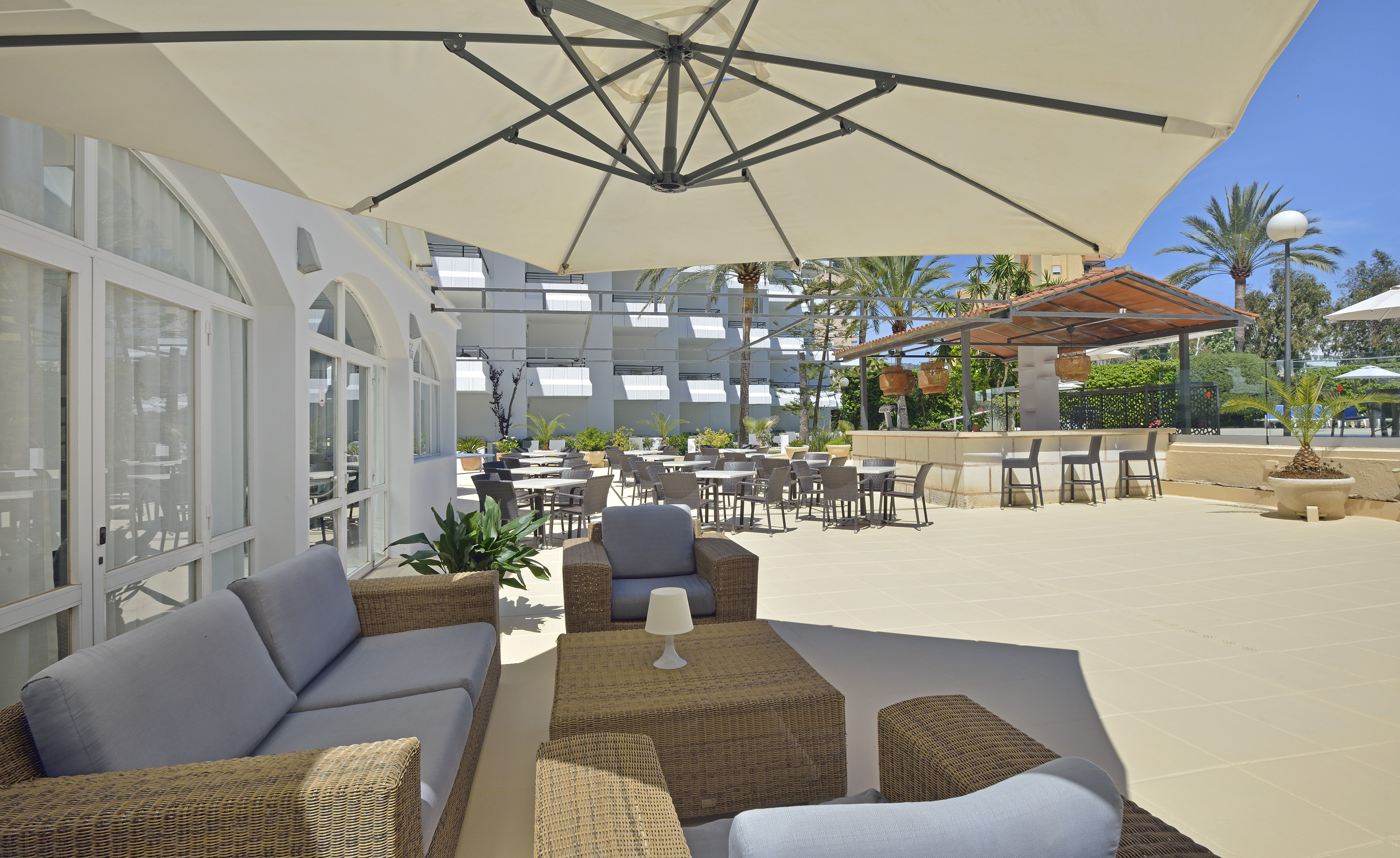 a patio area with chairs and tables