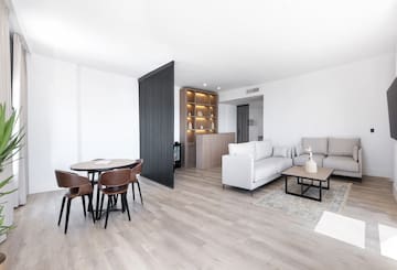 a living room with a table and chairs