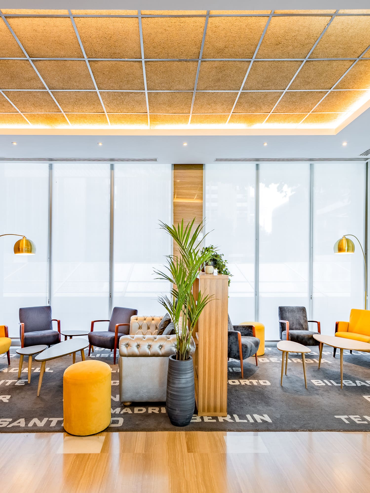 a room with a brick wall and a large window