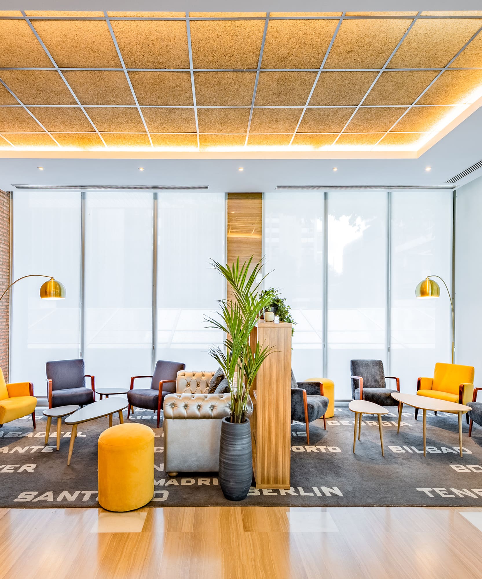 a room with a brick wall and a large window