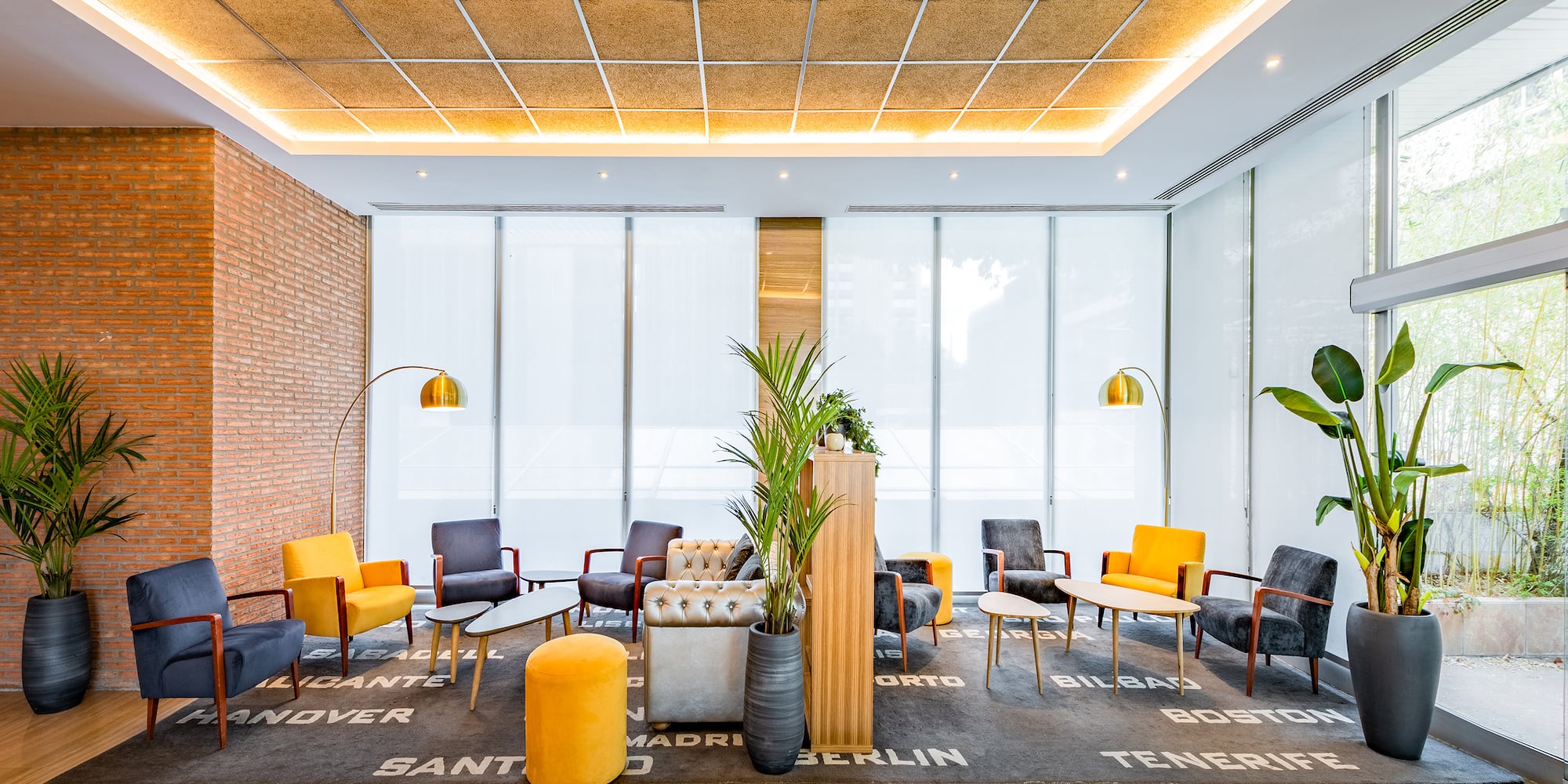 a room with a brick wall and a large window