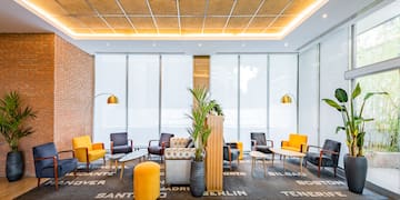 a room with a brick wall and a large window