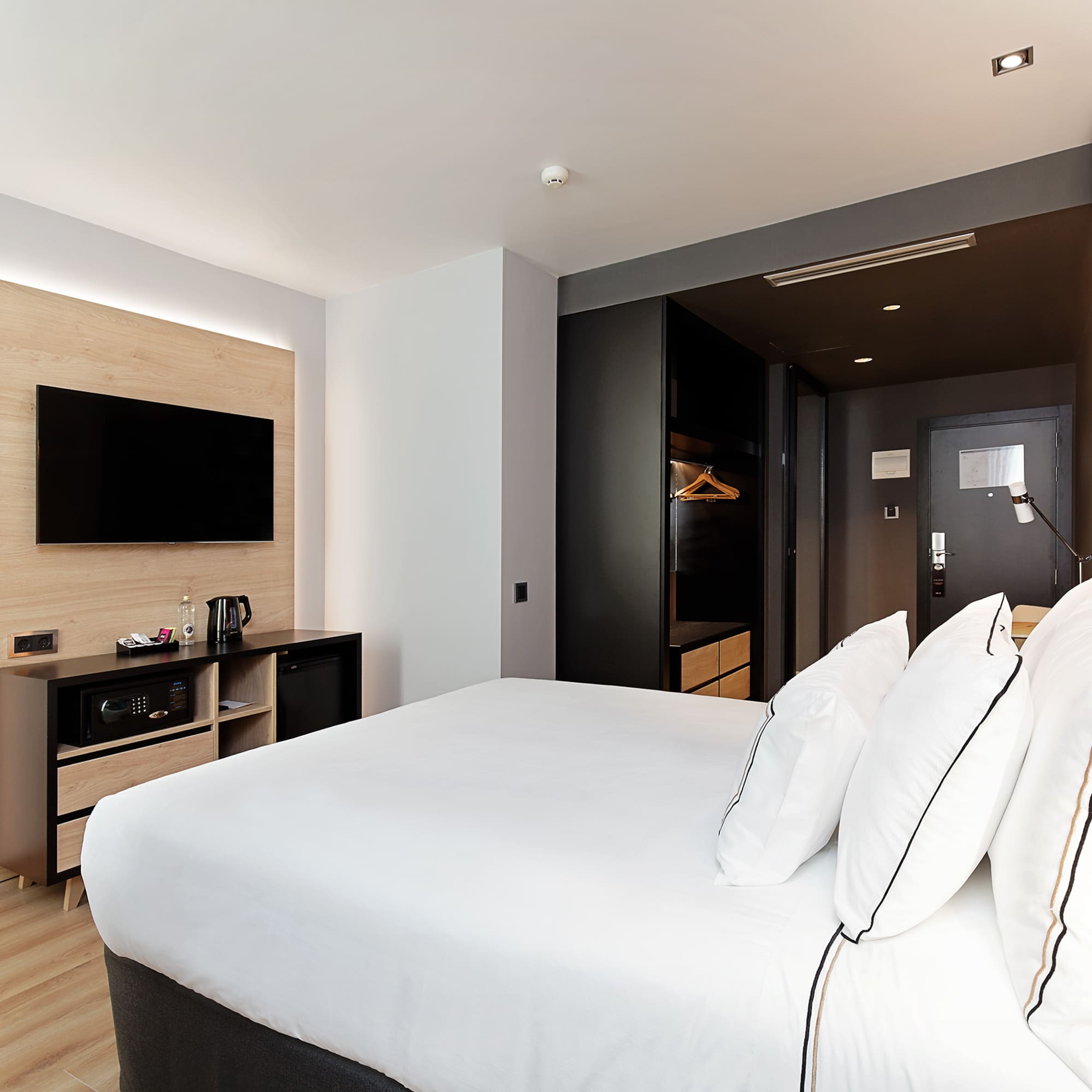 a room with a bed and a television