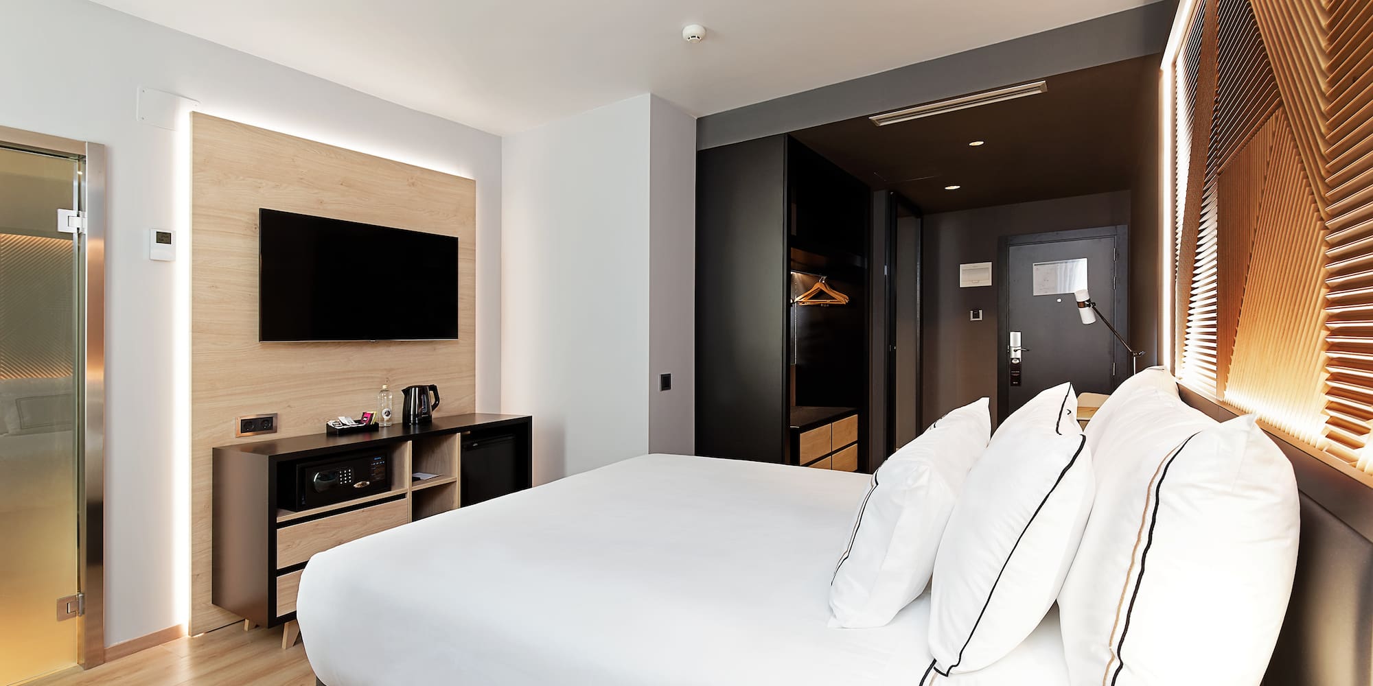 a room with a bed and a television