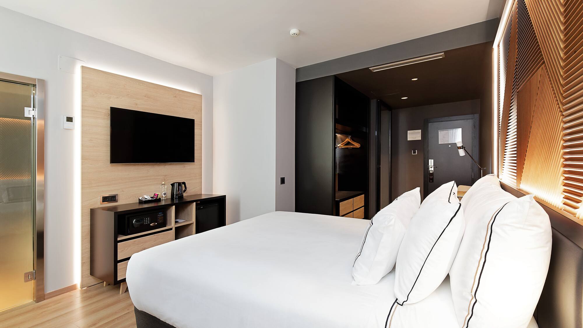 a room with a bed and a television