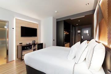 a room with a bed and a television