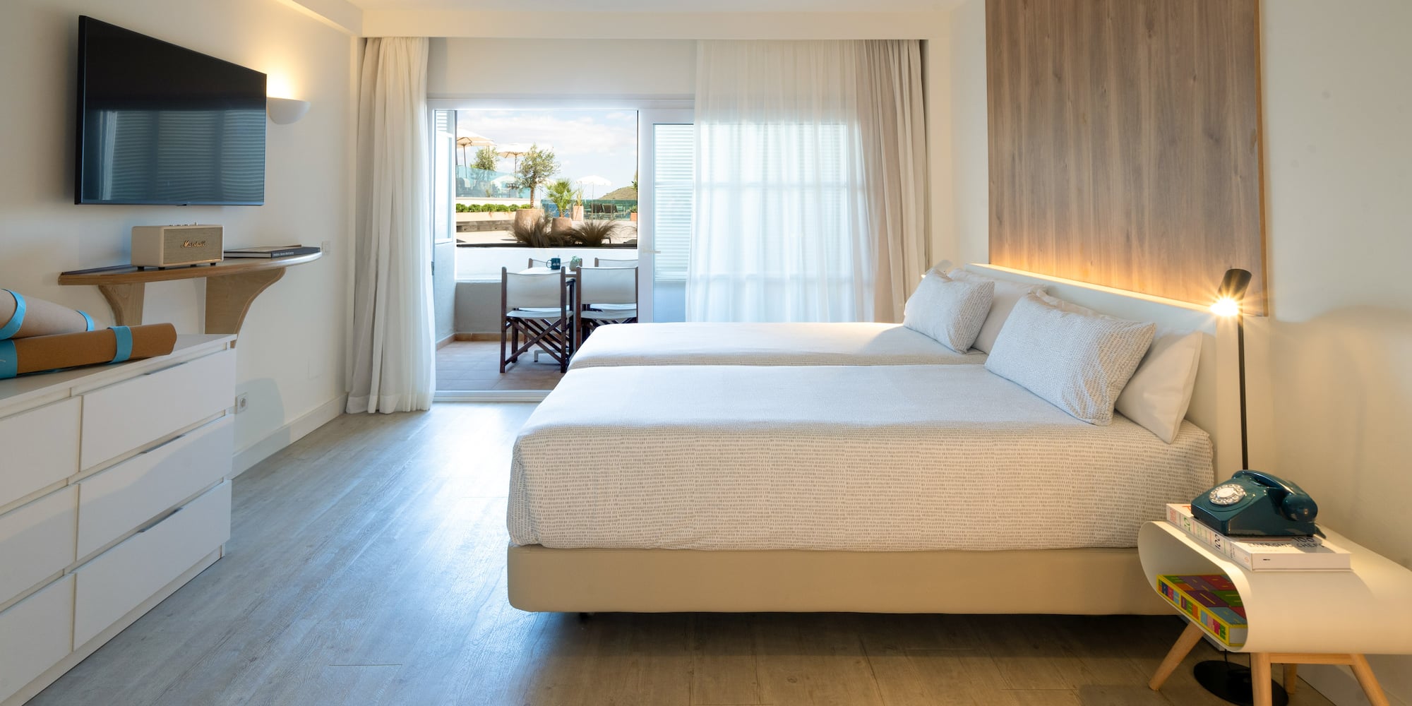 a room with two beds and a television