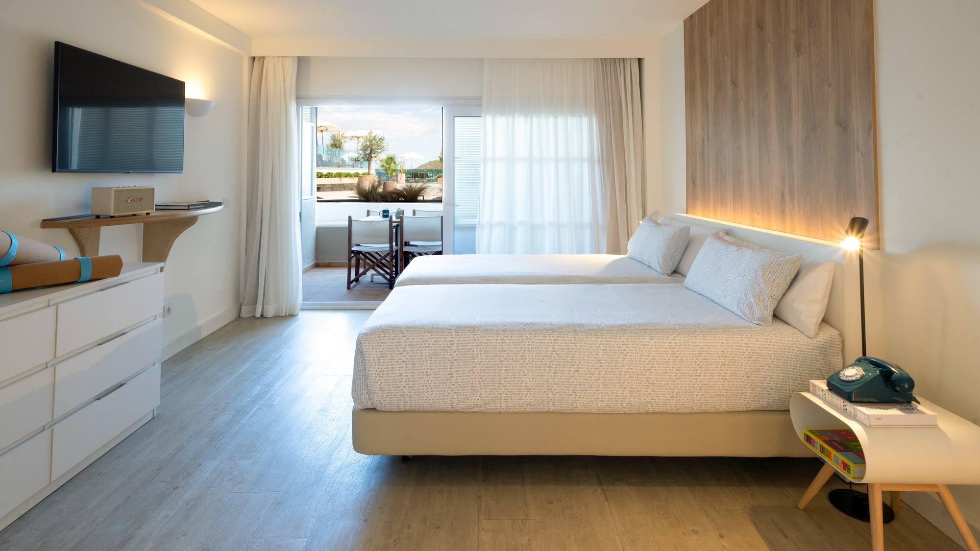 a room with two beds and a television