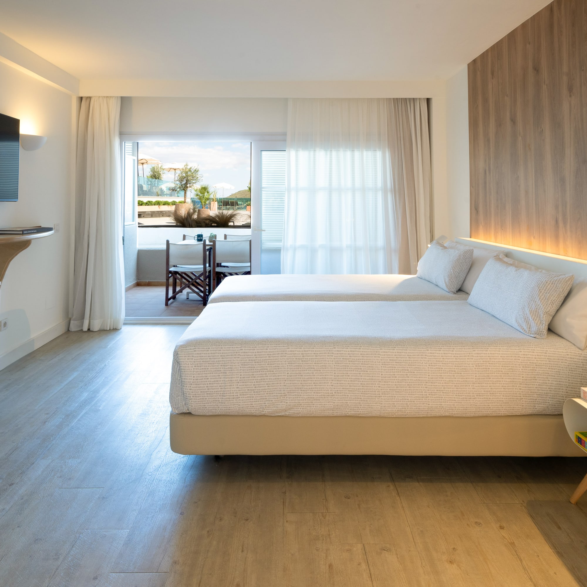 a room with two beds and a television