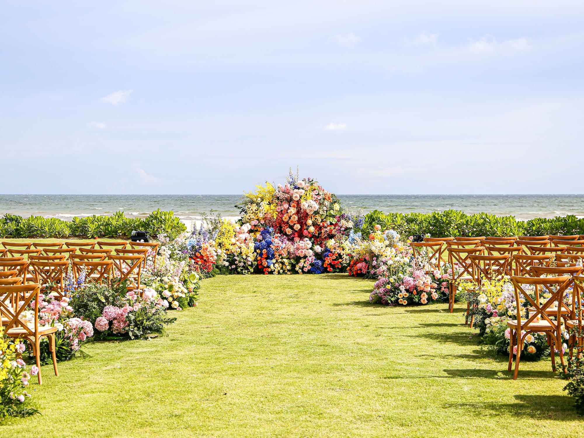a wedding ceremony with chairs and flowers