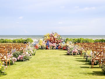 a wedding ceremony with chairs and flowers