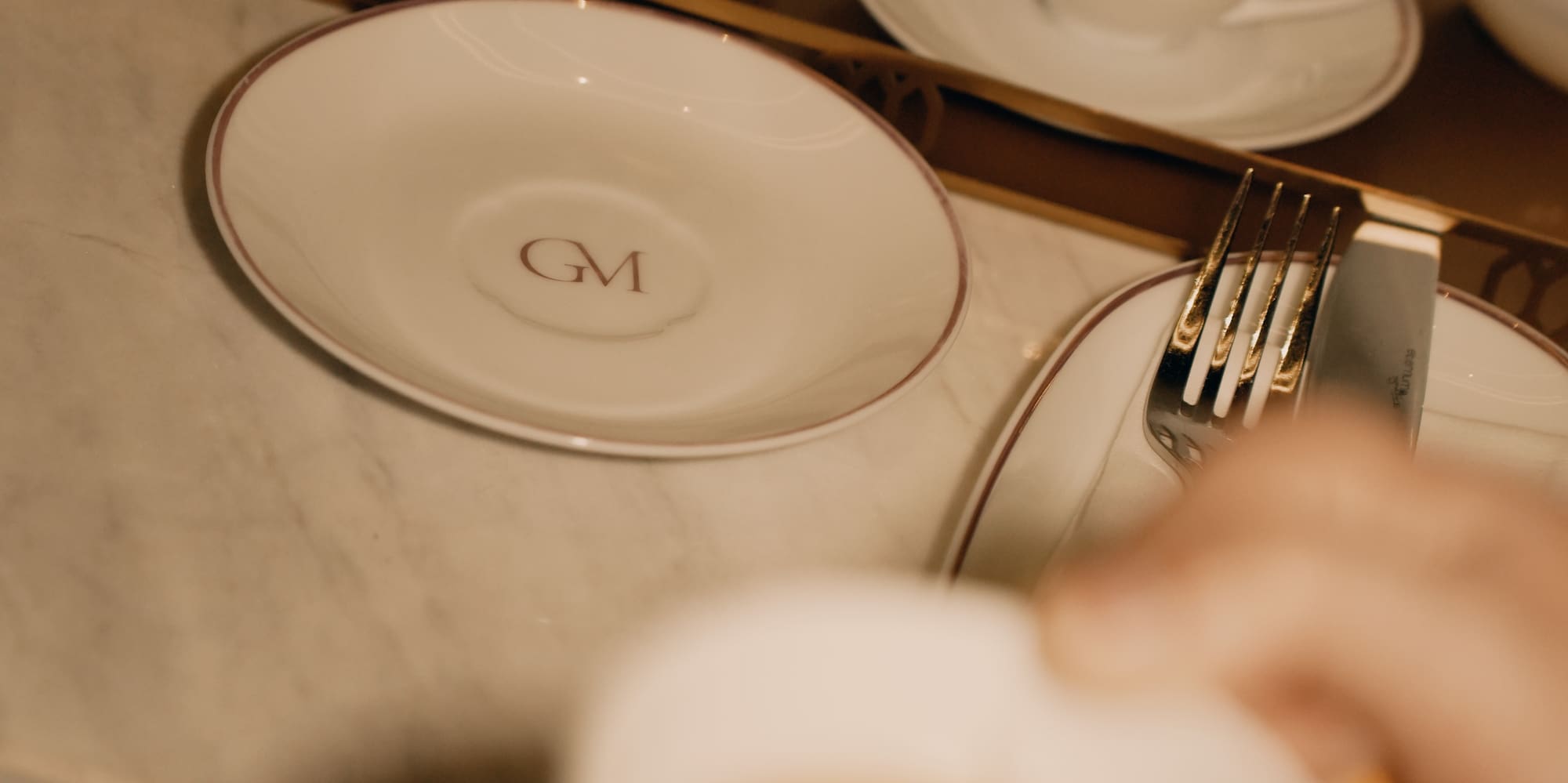 a hand holding a cup of tea