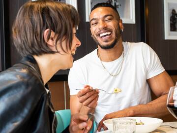 a man and woman laughing at each other