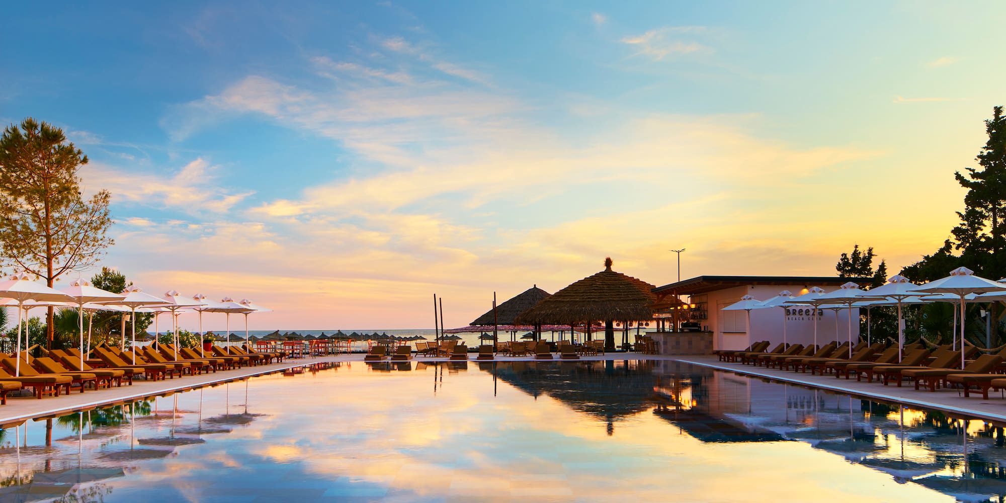 a pool with umbrellas and chairs