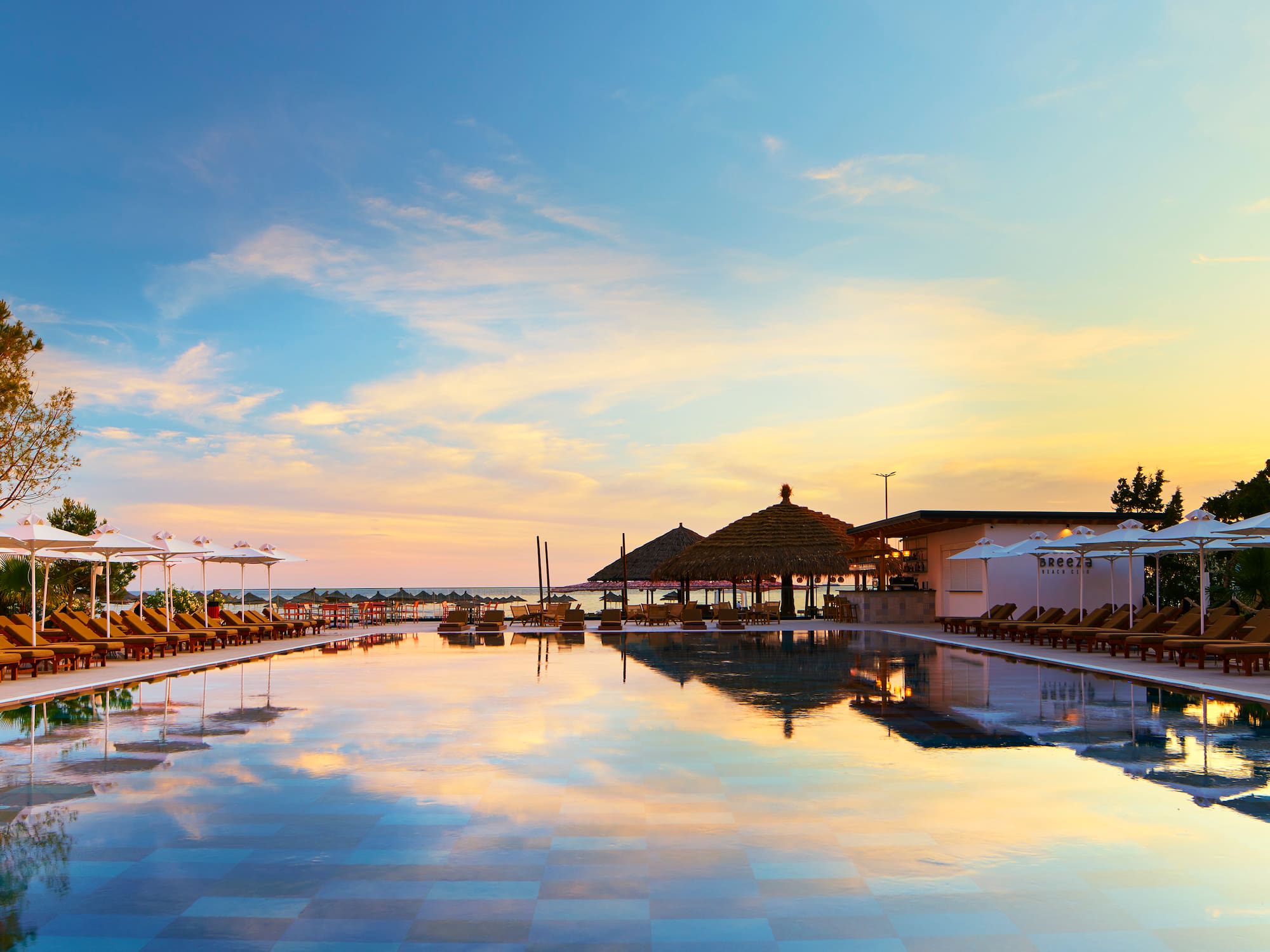 a pool with umbrellas and chairs