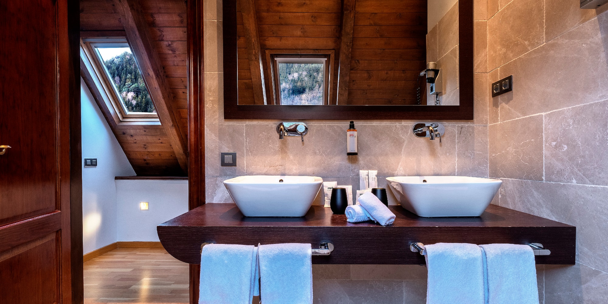 a bathroom with two sinks and a mirror