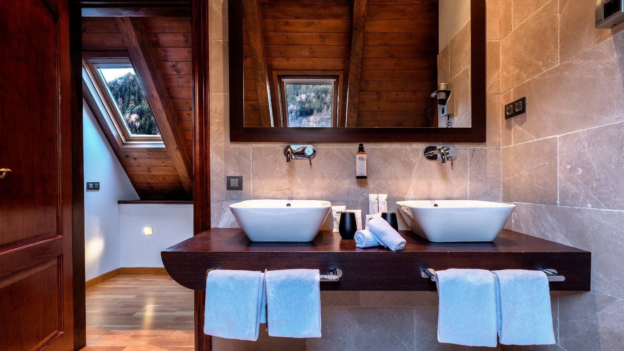 a bathroom with two sinks and a mirror