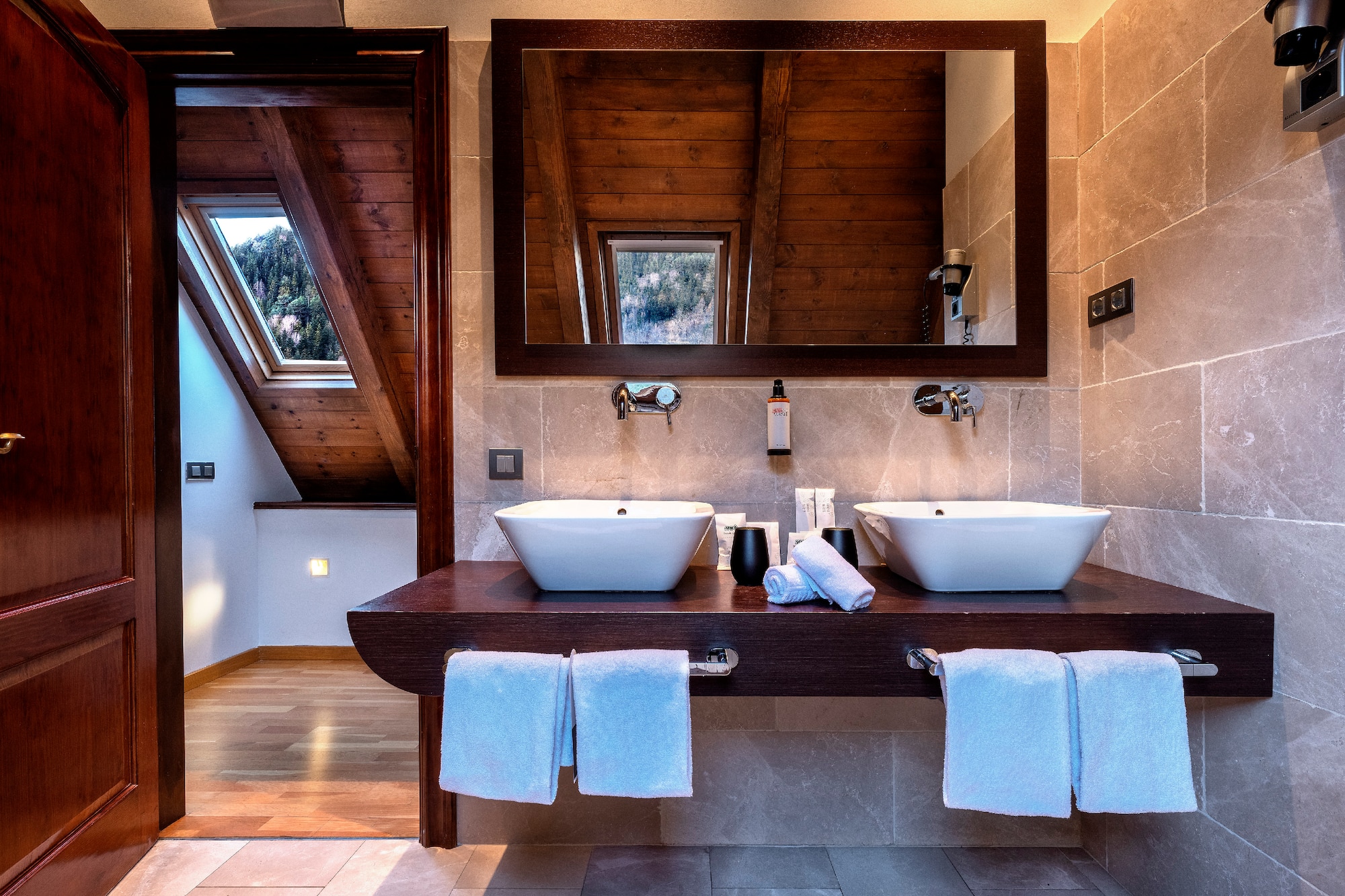 a bathroom with two sinks and a mirror