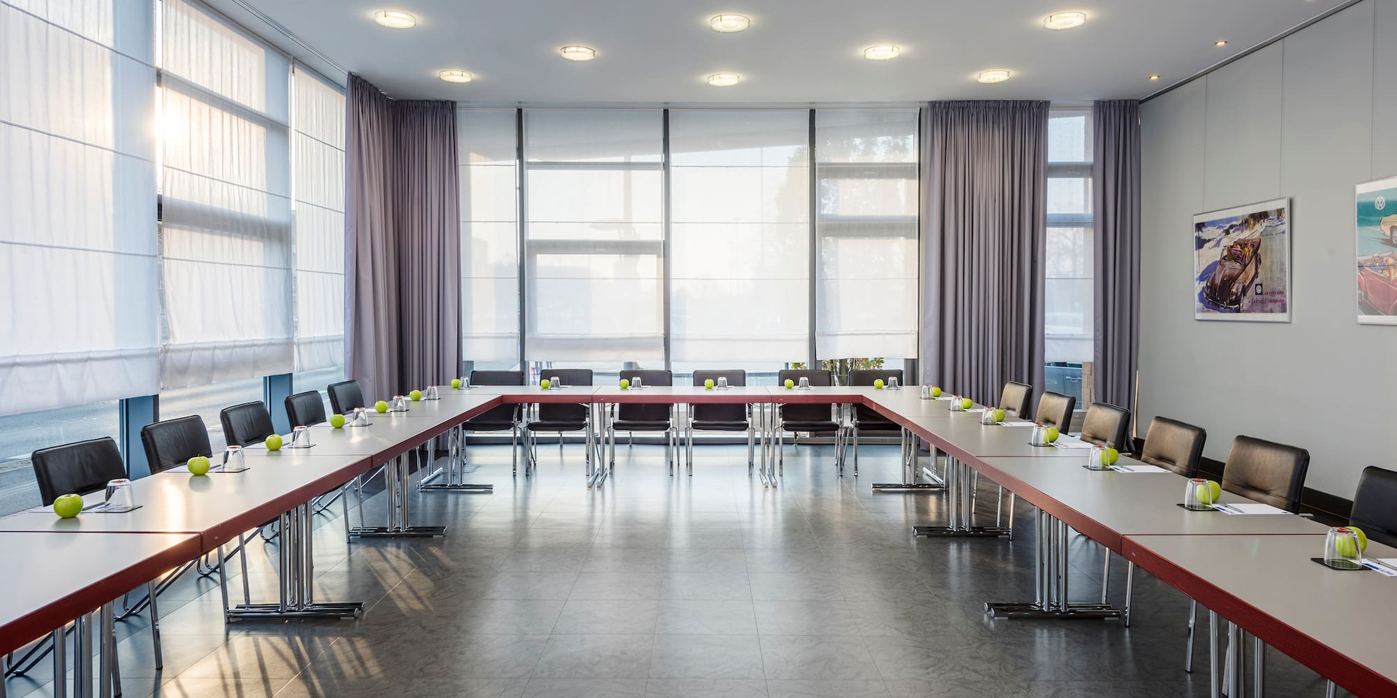 a room with long tables and chairs