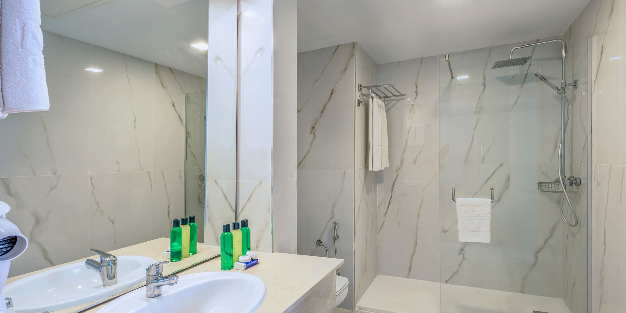 a bathroom with marble walls and a shower