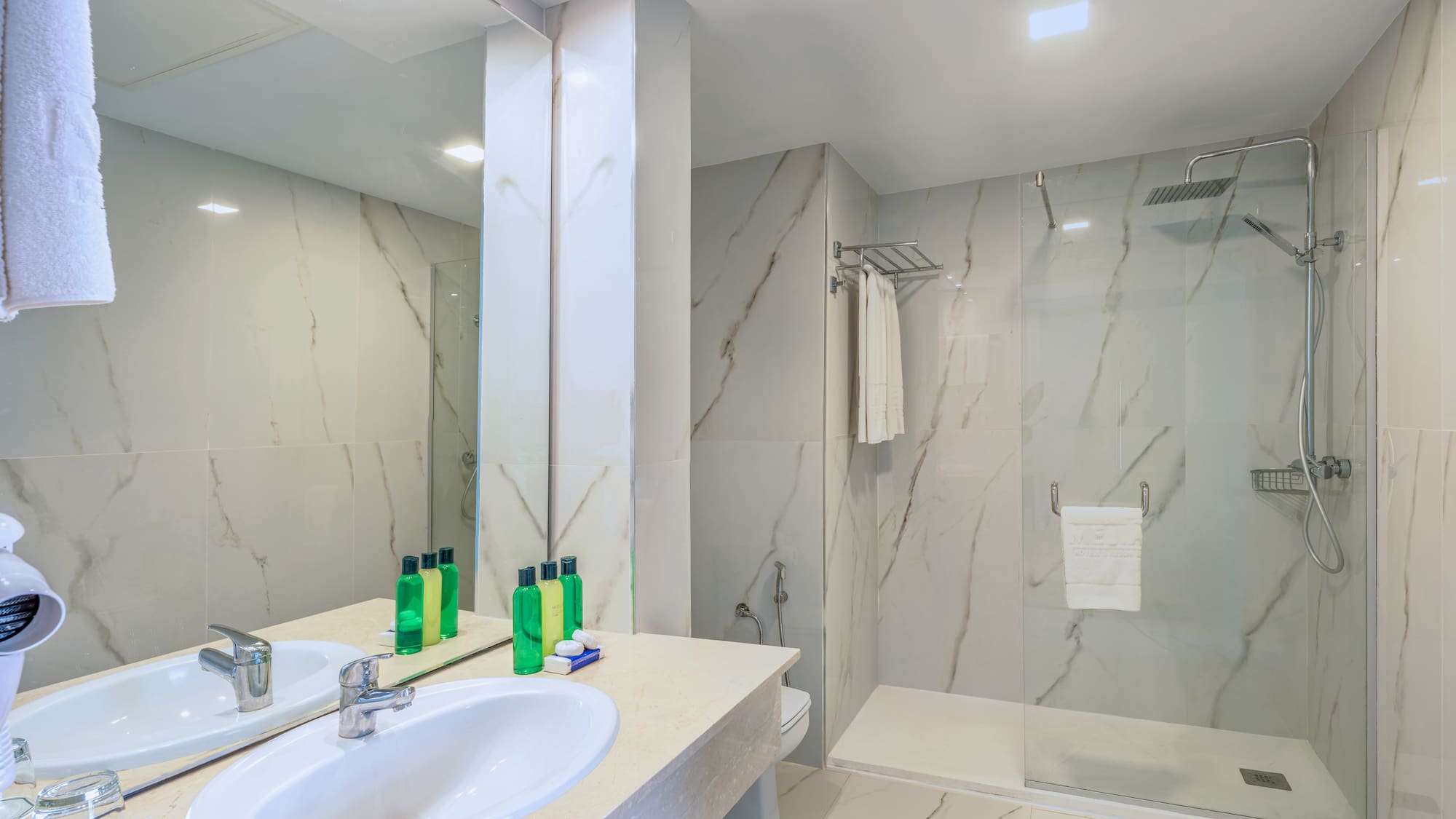 a bathroom with marble walls and a shower