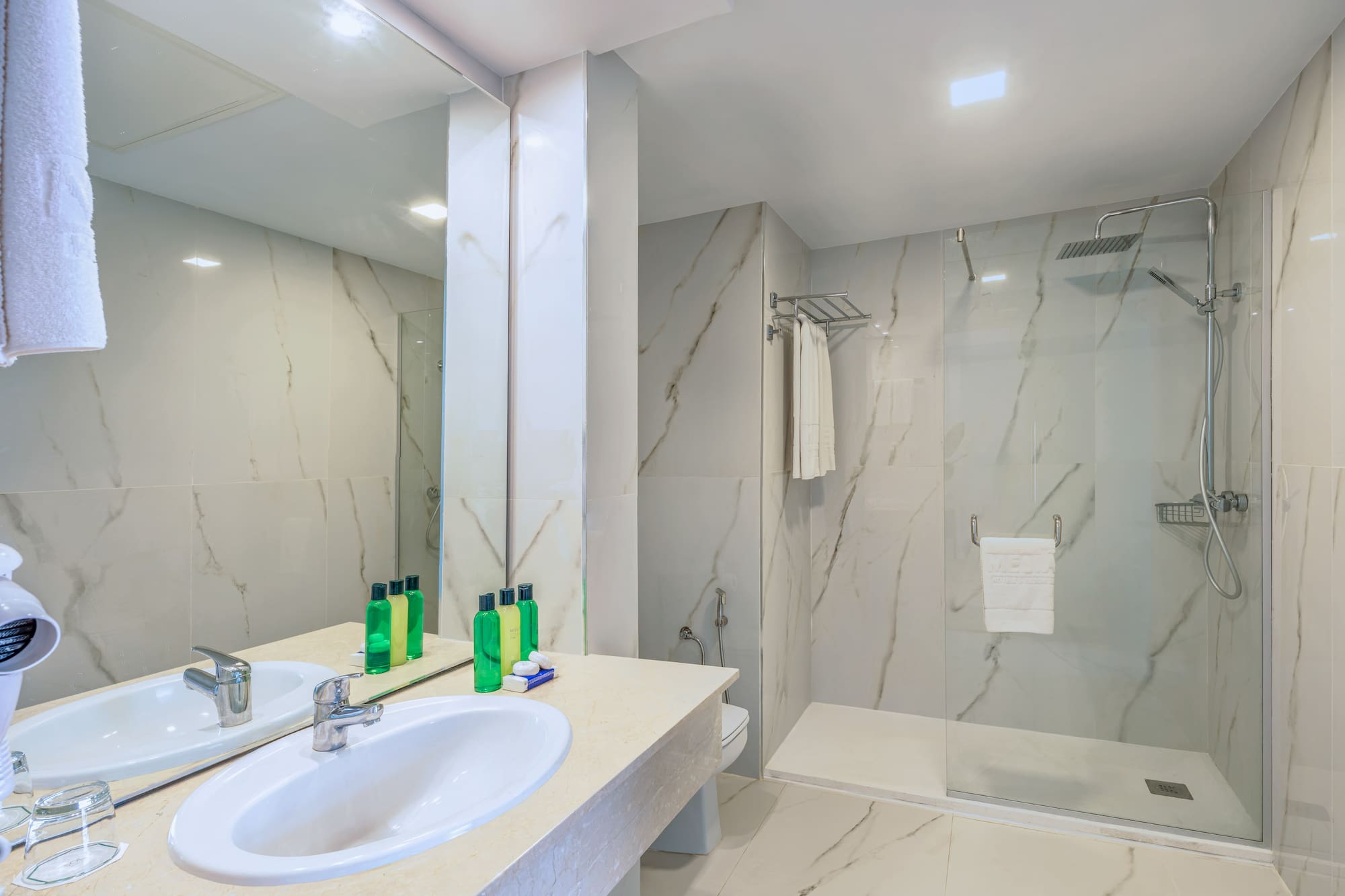 a bathroom with marble walls and a shower