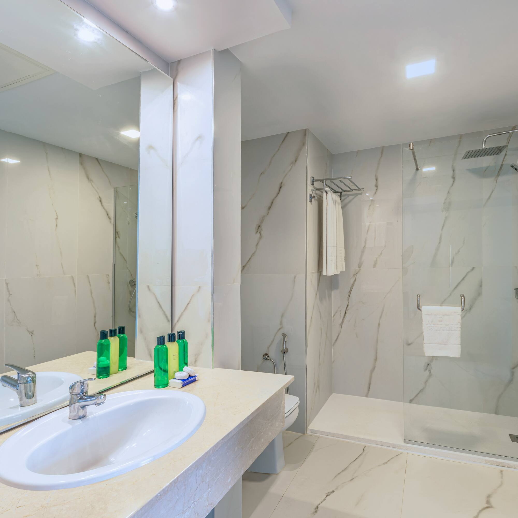 a bathroom with marble walls and a shower